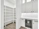 Well-lit pantry featuring ample shelving and a built-in beverage fridge at 18225 W San Juan Ct, Litchfield Park, AZ 85340