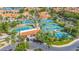 Aerial view of tennis courts surrounded by homes with tile roofs and palm trees, showcasing community recreation at 1835 E Marquette Dr, Gilbert, AZ 85234