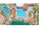 Aerial view of a community pool, tennis court, and lakefront amenities offer residents recreation and relaxation at 1835 E Marquette Dr, Gilbert, AZ 85234