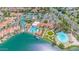 Aerial view of community amenities with lake access, pools, tennis courts, clubhouse, sandy beach, and green spaces at 1835 E Marquette Dr, Gilbert, AZ 85234