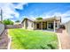 This backyard has lush grass, desert landscaping, and a covered patio, perfect for relaxing at 1835 E Marquette Dr, Gilbert, AZ 85234