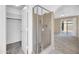Shower and walk-in closet with tile surround in the bathroom located off the main bedroom at 1835 E Marquette Dr, Gilbert, AZ 85234
