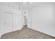 This carpeted bedroom features a closet, ceiling fan and view into the ensuite at 1835 E Marquette Dr, Gilbert, AZ 85234