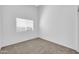 This spacious bedroom features neutral carpet, ample natural light and a ceiling fan at 1835 E Marquette Dr, Gilbert, AZ 85234