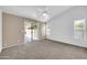 Bright bedroom featuring neutral carpeting, ample natural light, and sliding door at 1835 E Marquette Dr, Gilbert, AZ 85234