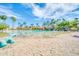 Community pool with sandy beach entry, palm trees, and fun water features for residents at 1835 E Marquette Dr, Gilbert, AZ 85234