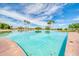 Large community pool surrounded by palm trees and lounge areas at 1835 E Marquette Dr, Gilbert, AZ 85234