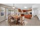 Cozy dining area with a large table, flowing into the open-concept kitchen at 1835 E Marquette Dr, Gilbert, AZ 85234