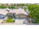 Aerial view of a charming two-story home with a well-maintained lawn, tiled roof and a spacious three-car garage at 1835 E Marquette Dr, Gilbert, AZ 85234
