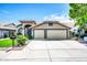 Charming home with a two-car garage, tiled roof, and a well-manicured front yard at 1835 E Marquette Dr, Gilbert, AZ 85234