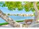 Beautiful lake view showcasing waterfront homes, a scenic bench, and lush landscaping at 1835 E Marquette Dr, Gilbert, AZ 85234