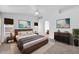 Stylishly staged bedroom with modern furnishings and decor plus ensuite bathroom access at 1835 E Marquette Dr, Gilbert, AZ 85234