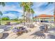 Palm patio surrounded by lush landscaping, comfortable seating, and a relaxing atmosphere at 1835 E Marquette Dr, Gilbert, AZ 85234
