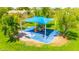 The playground features colorful slides and a swing set, all shaded by a blue canopy for sunny days at 1835 E Marquette Dr, Gilbert, AZ 85234
