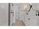 Modern bathroom with glass shower, double vanity, and stylish lighting fixtures at 20326 W Roma Ave, Buckeye, AZ 85396
