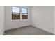 Cozy bedroom features neutral carpet, bright windows with nice backyard view at 20326 W Roma Ave, Buckeye, AZ 85396