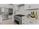 This well-appointed kitchen features stainless steel appliances, and white cabinets with modern hardware at 20326 W Roma Ave, Buckeye, AZ 85396