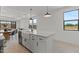 Stylish kitchen island features seating, ample storage, and a modern farmhouse sink at 20326 W Roma Ave, Buckeye, AZ 85396