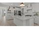 Bright kitchen features a large island, stainless steel appliances, and white cabinets with black hardware at 20326 W Roma Ave, Buckeye, AZ 85396