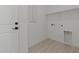 A laundry room with tile floors featuring a built-in shelf above the washer-dryer hookups at 20326 W Roma Ave, Buckeye, AZ 85396