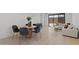 Modern living room featuring a stylish dining area and sliding glass doors to the outdoor space at 20326 W Roma Ave, Buckeye, AZ 85396