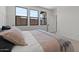 Bright main bedroom featuring large windows, neutral decor, and comfortable bedding at 20326 W Roma Ave, Buckeye, AZ 85396