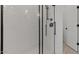 Modern shower with black trim and rainfall shower head, complemented by white subway tile at 20326 W Roma Ave, Buckeye, AZ 85396