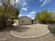 Desert landscaped backyard with a circular walkway, mature trees, and a covered patio at 2042 N Parish N Ln, Casa Grande, AZ 85122