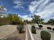 Large backyard with drought-tolerant landscaping and lush green bushes along the fence line at 2042 N Parish N Ln, Casa Grande, AZ 85122