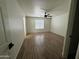 A bright bedroom featuring wood-look flooring and a modern ceiling fan at 2042 N Parish N Ln, Casa Grande, AZ 85122