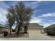 Charming single-story home with a well-maintained lawn, mature trees, and a two-car garage at 2042 N Parish N Ln, Casa Grande, AZ 85122