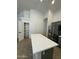 Kitchen with an island, stainless steel fridge, and pantry, maximizing space and functionality at 2042 N Parish N Ln, Casa Grande, AZ 85122