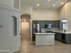 Bright, open kitchen with an island, stainless appliances, and a view of the front entryway at 2042 N Parish N Ln, Casa Grande, AZ 85122