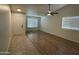 Living room featuring hardwood floors, bright windows, and ceiling fan at 2042 N Parish N Ln, Casa Grande, AZ 85122