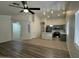 Open concept living room and kitchen with stainless steel appliances and ceiling fan at 2042 N Parish N Ln, Casa Grande, AZ 85122