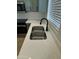 Close up on the stainless steel sink, countertop, and faucet with a window in the background at 2042 N Parish N Ln, Casa Grande, AZ 85122