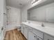 Bathroom features double sinks, and shower over tub with white cabinets at 21334 E Lords Ct, Queen Creek, AZ 85142