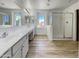 Elegant bathroom with a double sink vanity, large mirrors, and a glass-enclosed shower at 21334 E Lords Ct, Queen Creek, AZ 85142