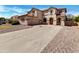 Two-story home with a spacious driveway and well-maintained landscaping at 21334 E Lords Ct, Queen Creek, AZ 85142