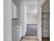 Hallway with cabinets, leading to a view of a well-lit living area at 21334 E Lords Ct, Queen Creek, AZ 85142