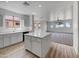 Beautiful kitchen featuring an island with white cabinets and modern light fixtures at 21334 E Lords Ct, Queen Creek, AZ 85142