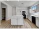 Bright kitchen featuring a large island, white cabinets, and modern black appliances at 21334 E Lords Ct, Queen Creek, AZ 85142