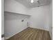 Laundry room features wood-look floors, shelving and hookups at 21334 E Lords Ct, Queen Creek, AZ 85142
