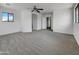 Open main bedroom with neutral walls, carpet, modern ceiling fan, and a light-filled atmosphere at 21334 E Lords Ct, Queen Creek, AZ 85142