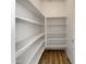 Walk-in pantry with ample white shelving and wood-look floors at 21334 E Lords Ct, Queen Creek, AZ 85142