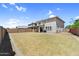 Expansive backyard with lawn, block wall, covered patio and ample space at 21716 S 225Th Way, Queen Creek, AZ 85142