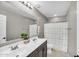 Bathroom featuring double sinks, large mirror, shower-tub combo, and decorative towels at 21716 S 225Th Way, Queen Creek, AZ 85142