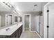 Bathroom featuring a double vanity, tile floor, glass enclosed shower, and view into a separate toilet room at 21716 S 225Th Way, Queen Creek, AZ 85142