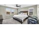 Spacious bedroom featuring a large bed, neutral colors, and plenty of natural light from three windows at 21716 S 225Th Way, Queen Creek, AZ 85142