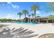 Inviting community pool with lounge chairs and palm trees at 21716 S 225Th Way, Queen Creek, AZ 85142